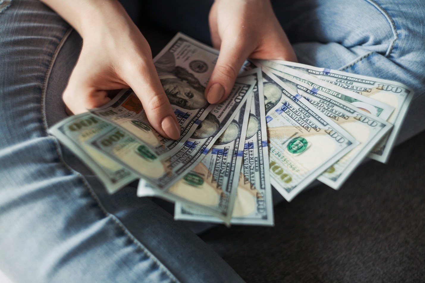A person fanning out a wad of cash