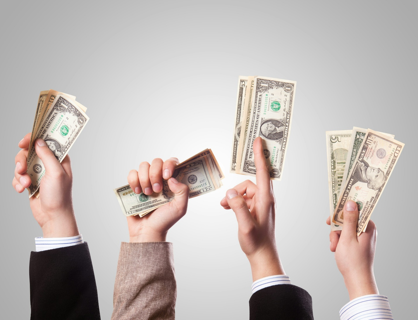 Multiple hands holding cash