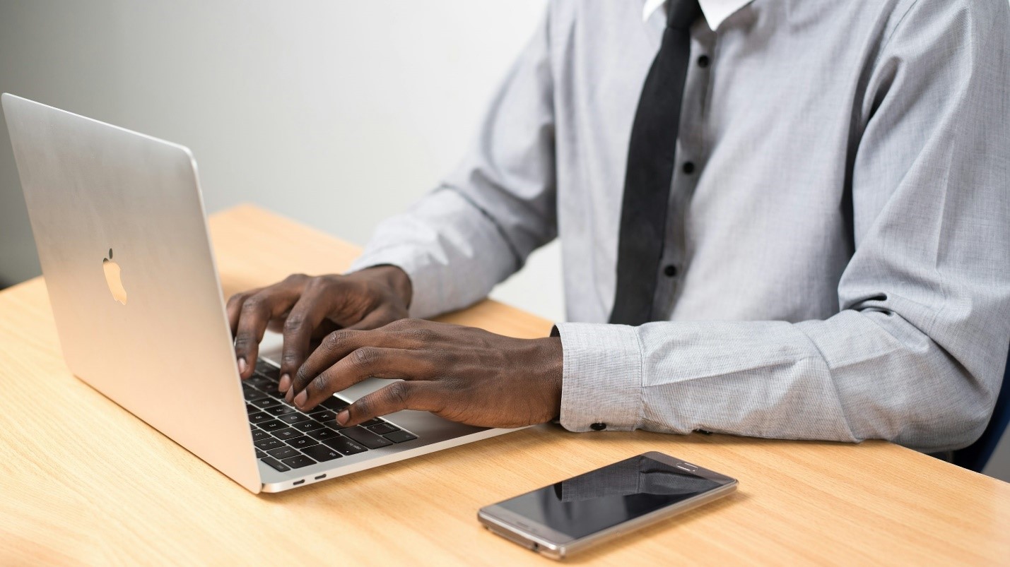 A person typing on a laptop